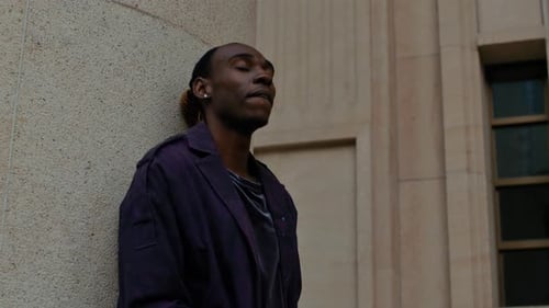 Carefree black Afro American male singer chills out outdoor alone , close up of man with modern clot