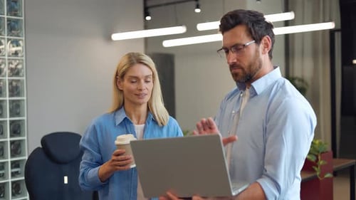 Business Professionals Discussing Ideas with Laptop in Office