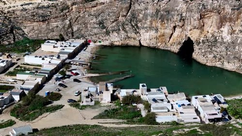High angle aerial view of Dwejra Inland Sea in Gozo during a sunny summer day featuring turquoise