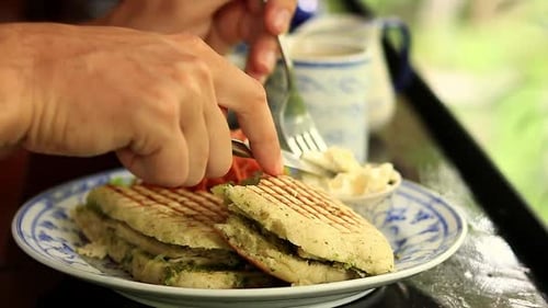 Close up to a vegan panini being topped with coconut cream for a healthy breakfast