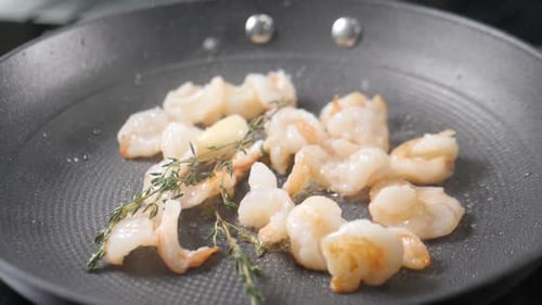 Shrimp Sizzling in a Pan with Thyme