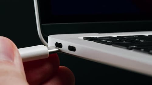 Charging Connection to Laptop on Black Background Closeup Phone Charging Port USB Wire for Devices