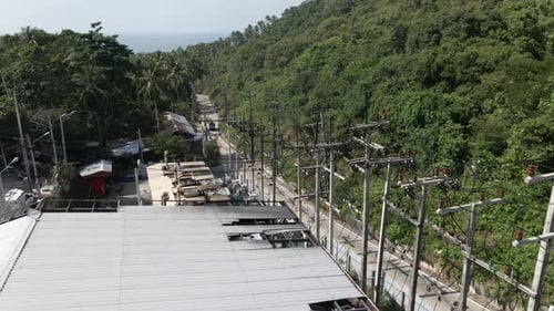 Cars Passing By a Dangerous Electricity Power Plant with a Lot of Pylons