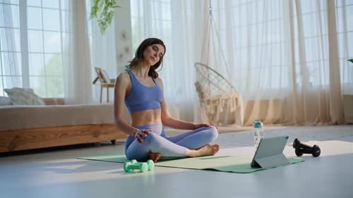 Sporty Woman Exercising Mat Watching Tutorial at Tablet Focused Lady Twisting
