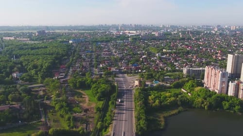 Aerial View of a Vast Urban Area with Beautiful Green Spaces and a Serene Waterway