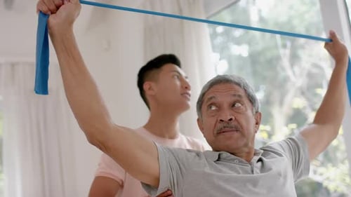 Senior Man Exercising with Assistance at Home