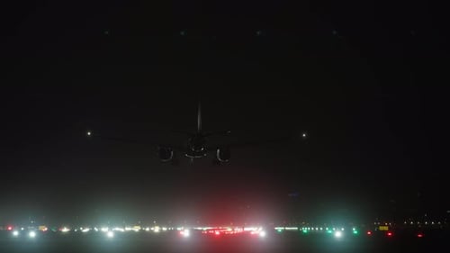 Night Landing Airplane on Illuminated Airport Runway