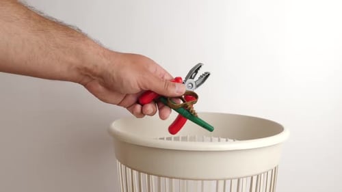E18. Old plastic children's toys are thrown into the trash can. Disposal of household waste.