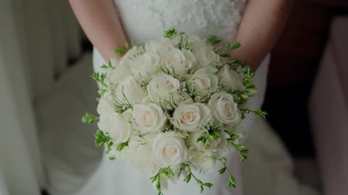 Bride Holding Beautiful Bouquet of White Roses