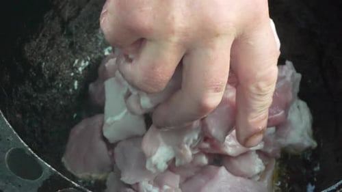 Adding Raw Meat Chunks to a Cooking Pot