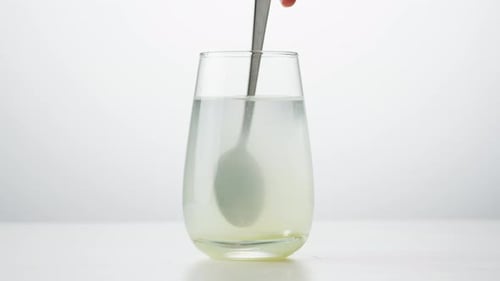 Stirring a Spoon in a Glass of Water