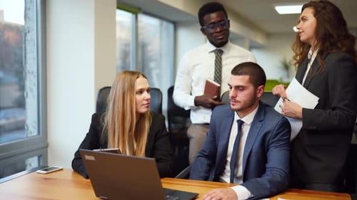 Diverse Office Corporate Workers Discuss Project on Laptop Display in Office Multiethnic People