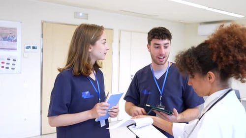 Medical Team Discussing Patient Information in Hospital Hallway