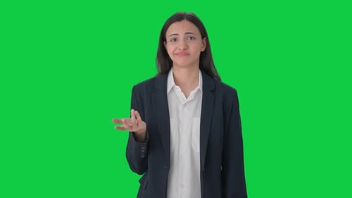 Confused Indian female manager asking What Green screen