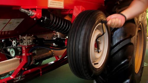 Close up of Man Working on Red Machine