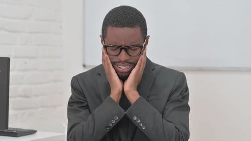 Bewildered Young African Businessman Expressing Confusion