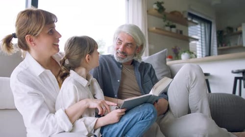 Grandfather, Mother and Child Reading a Book Together