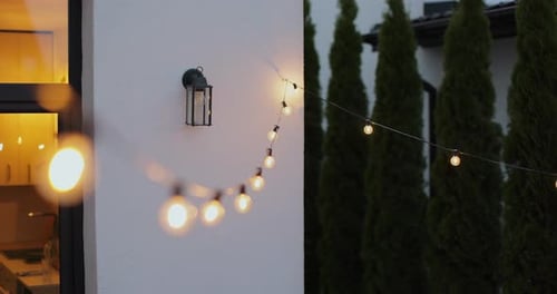 String Lights Hanging on Line on Outside House in Backyard Garden Decoration Party Camping