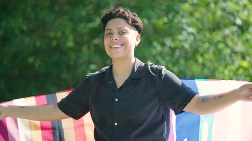 Young Adult Smiling with Pride Flag
