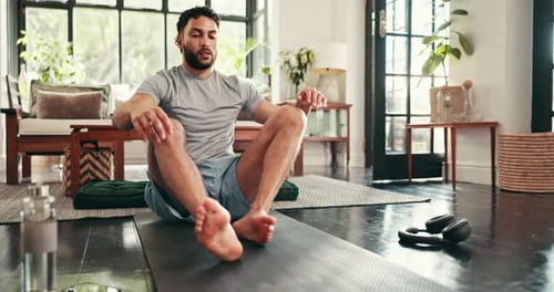 Adult Man Stretching Leg on Yoga Mat Indoors