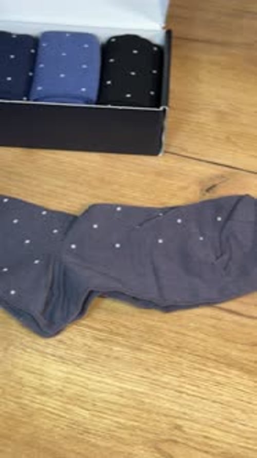 Colorful Dress Socks Being Unboxed on Wooden Table