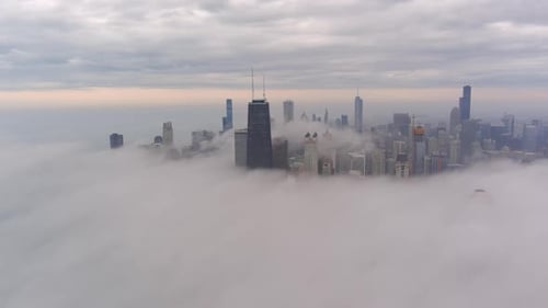 A chicago skyline consist of misty clouds. Foggy, white, beautiful, view of John Hancock tower and t