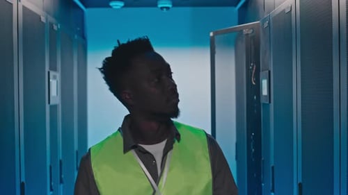 Focused Technician Interacts with Servers in Data Center