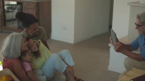 Happy Family Poses for Photo with Tablet