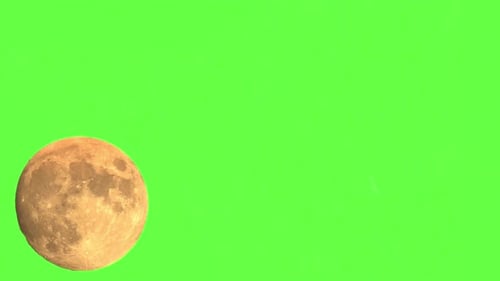 Large Illuminated Full Moon Moving Across A Green Screen Background