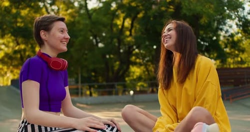 Two Friends Chatting at the Skate Park