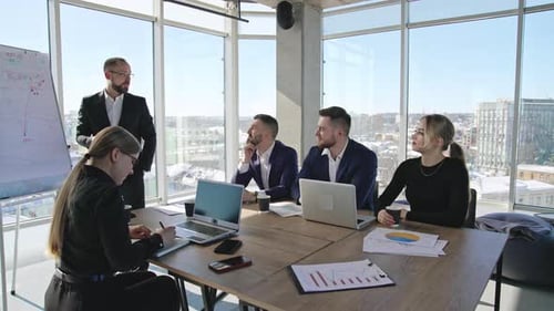 Team meeting in the spacious office. Business discussion and brainstorming with collegues.