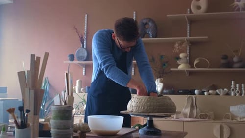 Man Potter Crumples a Piece of Raw Clay Male Artist Sculpts in a Pottery Studio Handmade Ceramics