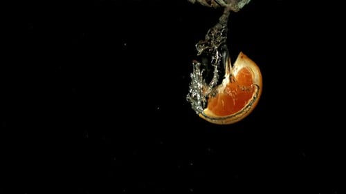 Orange Slices Fall Under Water Filmed is Slow Motion 1000 Fps