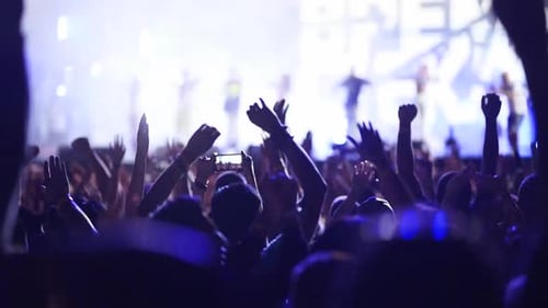 People Silhouettes Jump Waving Hands Taking Photos or Recording Videos of Live Music Concert with