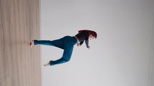 Athletic Woman with a Steep Stretch in Sportswear Performs Splits While Standing