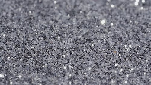 Macro slide shot, small silver sequins, shimmer in the light