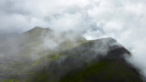 Flying Through Clouds Above Green Hills Paradise Heaven Mountain Range with High Peaks Wonderful