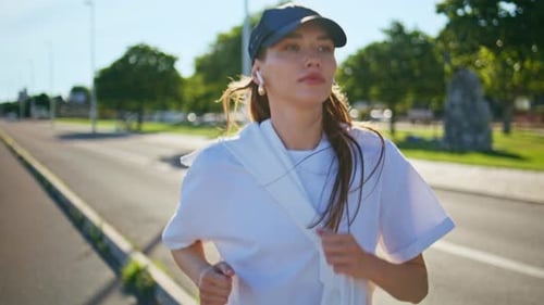 Woman Jogging on City Street in the Daytime