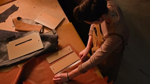 Young Craftswoman Working with Leather in Professional Studio