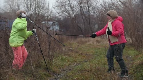 Senior Women Doing Nordic Walking in Autumn