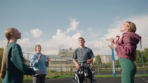 Young Adults Playing Volleyball on Urban Court
