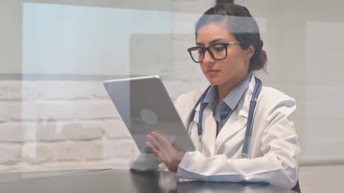 Female Doctor Using Tablet in Modern Office