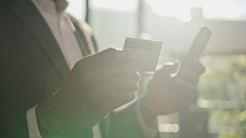 Close Up Male Hands Unrecognizable African American Man Hold Mobile Phone and Plastic Credit Card