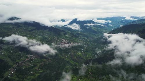 Georgian Mountains With Clouds. Village In Mountains Aerial View. Background Of Mountains And Clouds