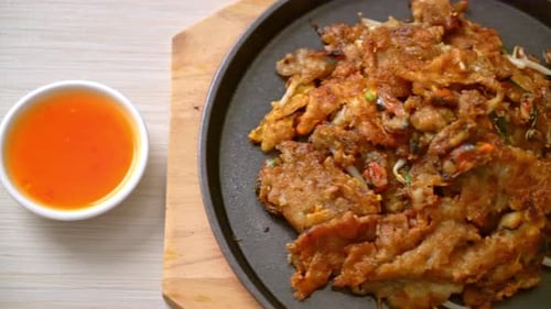 Crispy Oyster Pancake with Dipping Sauce on Skillet