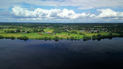A Breathtaking Aerial View Showcases the Serene River Winding Through a Vibrant Lush Green Landscape