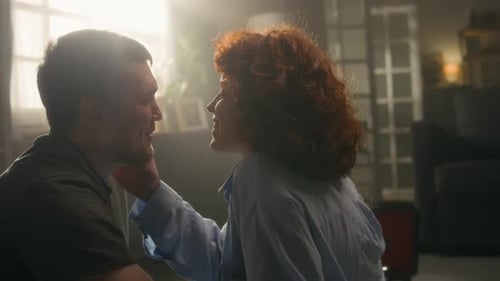 Woman Caressing Man's Face in Romantic Indoor Scene