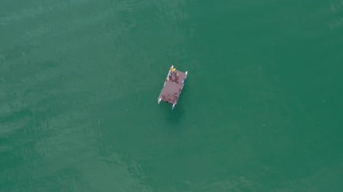 Aerial Top View Of A Raft Log Cabin Anchored On The Lake Perucac (Perućac), Western Serbia - aerial
