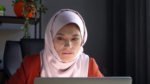 Close Up Video Capturing an Attractive Young Woman Wearing a Hijab Veil She is Working or Studying