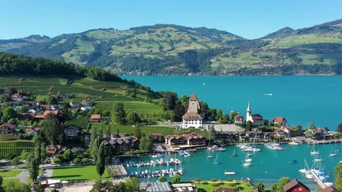 Aerial panoramic view of Spiez Church and Castle on the shore of Lake Thun in the Swiss canton of Be
